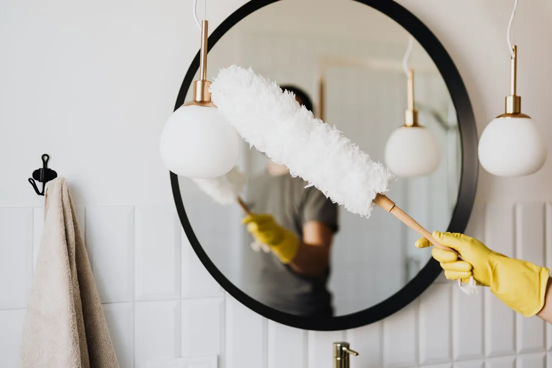 A Jbyrd cleaner dusting with attention to detail